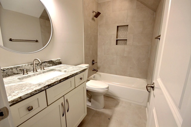 full bathroom featuring vanity, tile patterned flooring, toilet, and tiled shower / bath