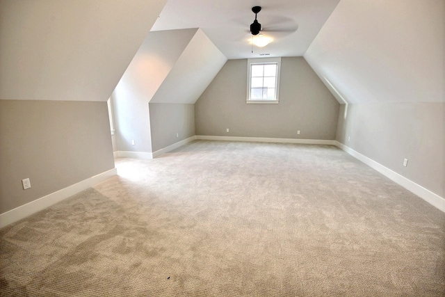 bonus room featuring ceiling fan, vaulted ceiling, and light colored carpet