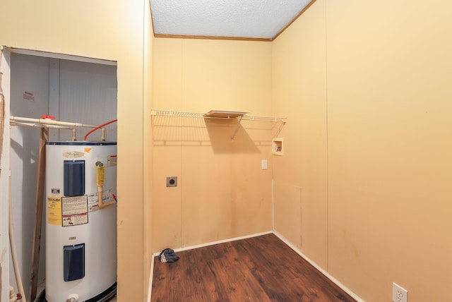 clothes washing area with water heater, dark hardwood / wood-style floors, washer hookup, ornamental molding, and a textured ceiling