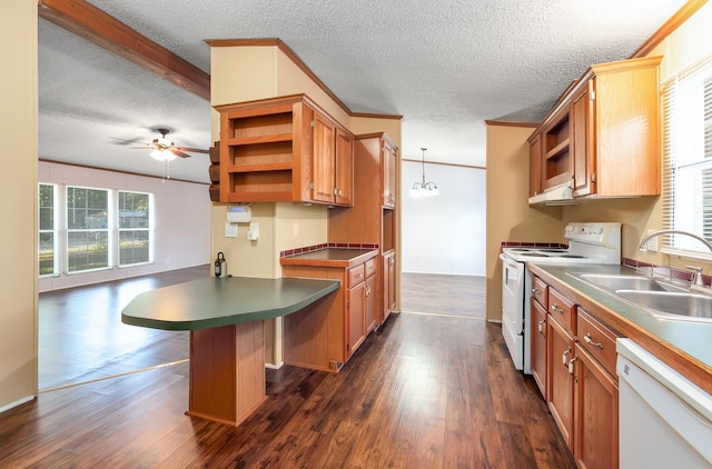 kitchen featuring pendant lighting, sink, white appliances, a kitchen breakfast bar, and dark hardwood / wood-style flooring