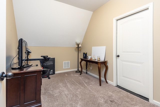 carpeted office space with vaulted ceiling