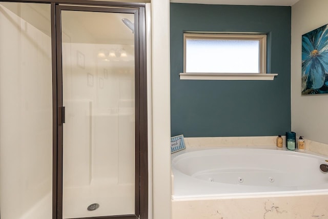 bathroom featuring separate shower and tub