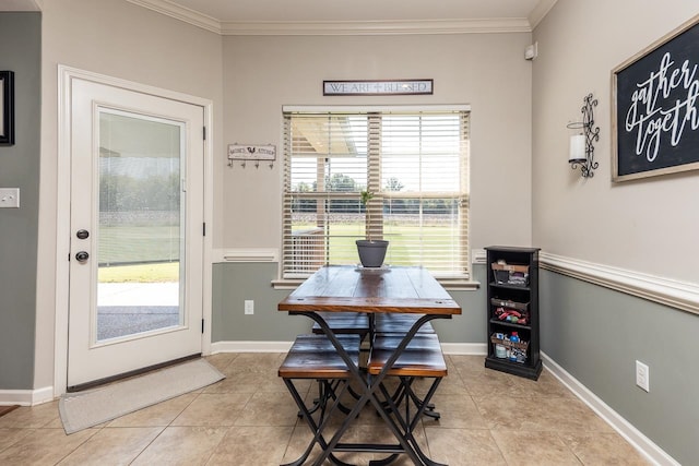 tiled dining space featuring ornamental molding and a wealth of natural light