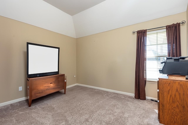 interior space featuring light colored carpet and vaulted ceiling