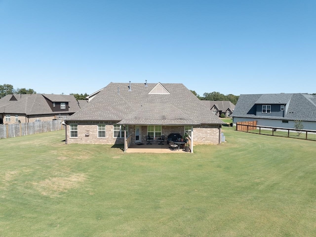 rear view of house with a yard and a patio area