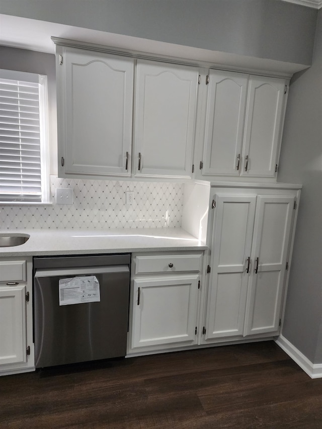 kitchen with decorative backsplash, stainless steel dishwasher, dark hardwood / wood-style floors, and white cabinets