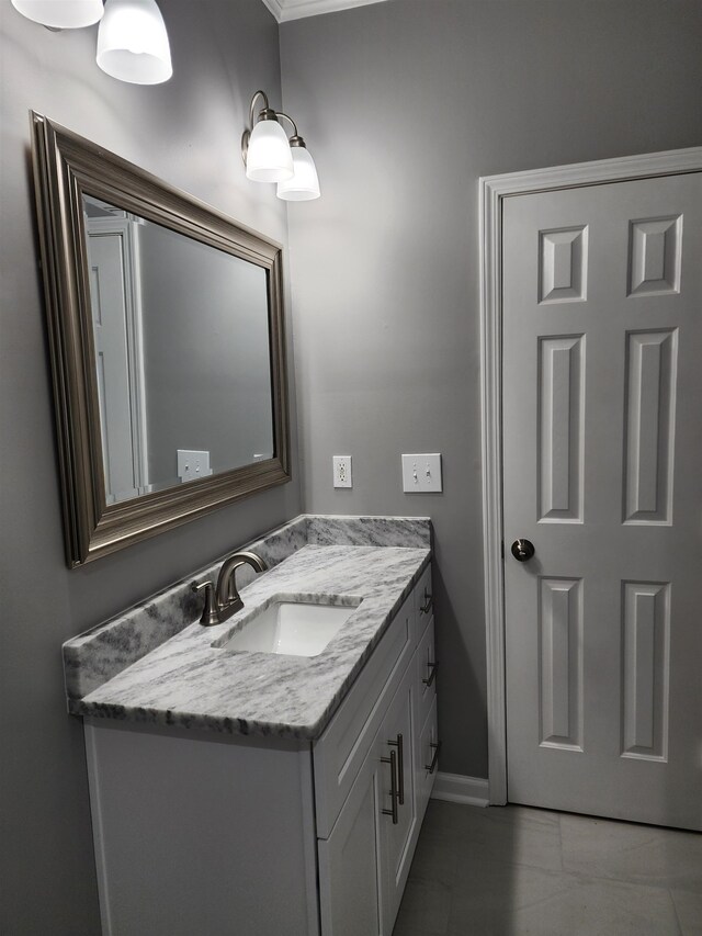 bathroom featuring crown molding and vanity