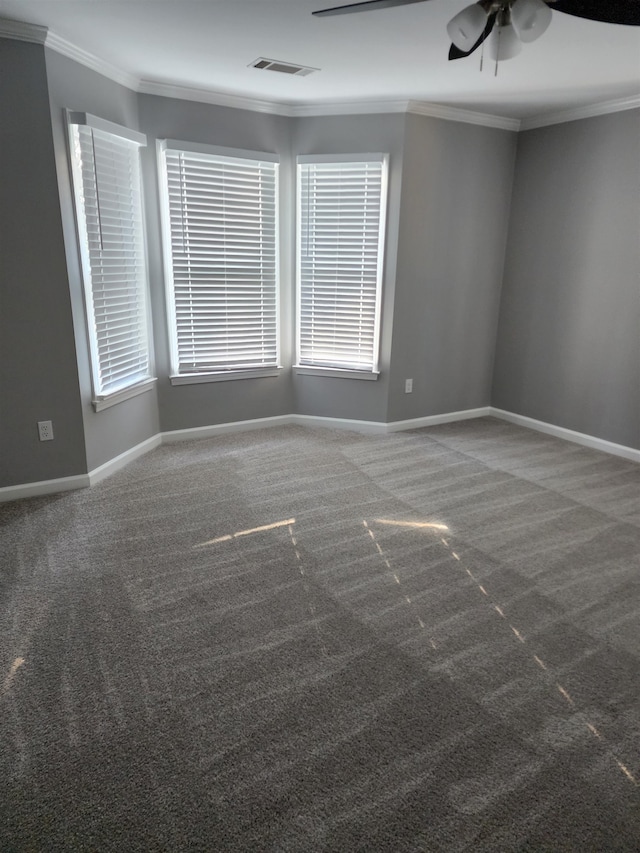 carpeted spare room with crown molding and ceiling fan