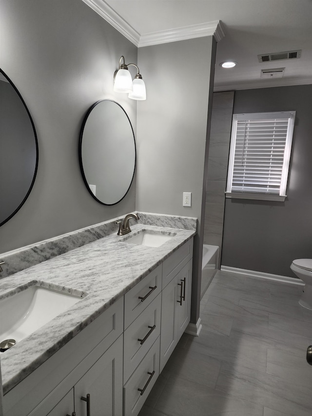 bathroom with ornamental molding, vanity, and toilet