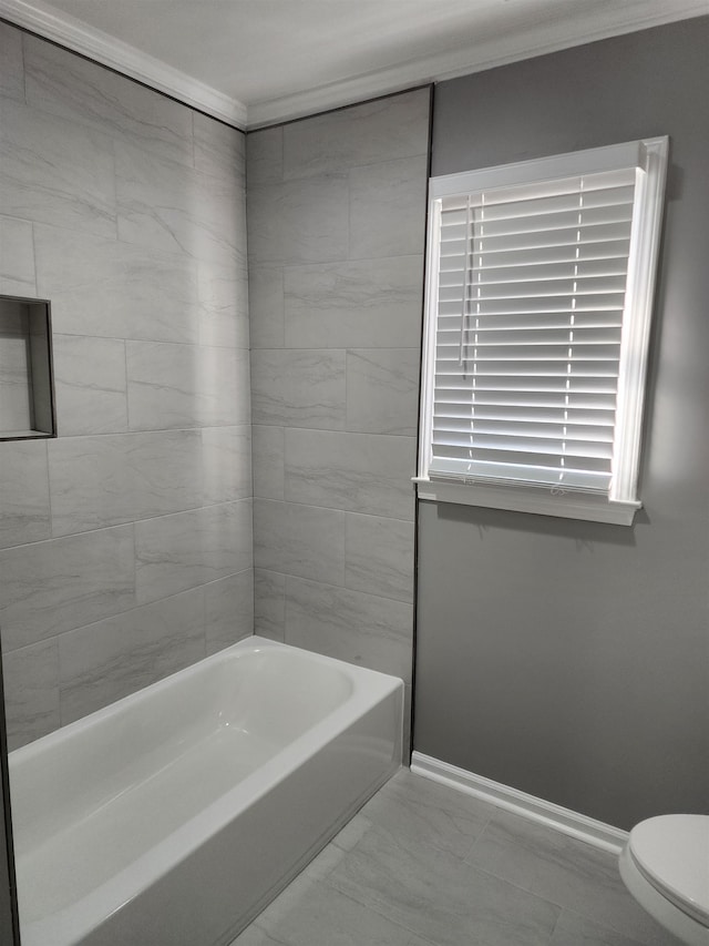 bathroom featuring tiled shower / bath and toilet