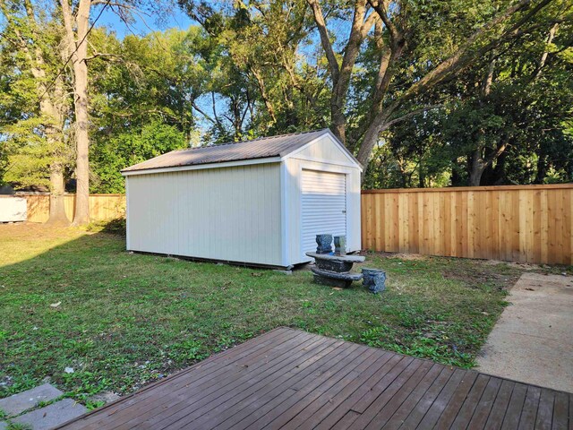 425 S Reese St S, Memphis, TN 38111 - view of yard featuring an outdoor structure, a wooden deck, a fenced backyard, and a storage shed