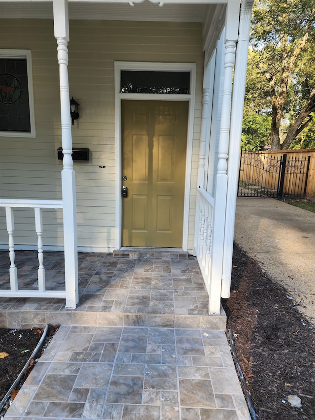 view of exterior entry featuring a porch