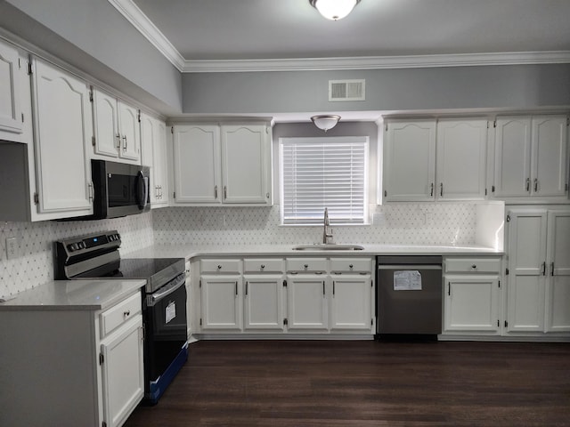 425 S Reese St S, Memphis, TN 38111 - kitchen with backsplash, electric stove, stainless steel dishwasher, a sink, and crown molding