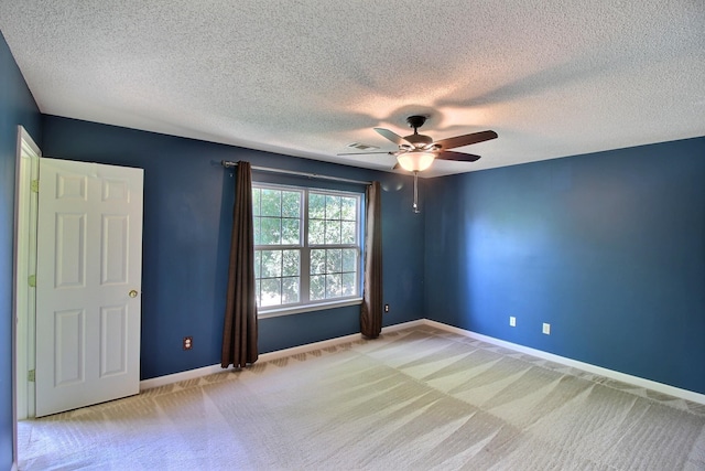 unfurnished room with light carpet, a textured ceiling, and ceiling fan