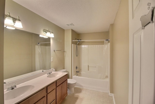 full bathroom featuring shower / bath combo with shower curtain, vanity, a textured ceiling, and toilet