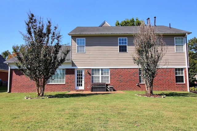 rear view of house featuring a yard and a patio