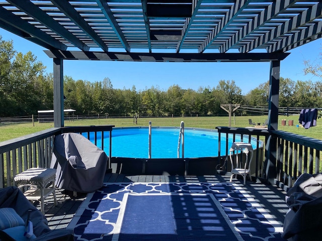 view of pool featuring a yard and a pergola