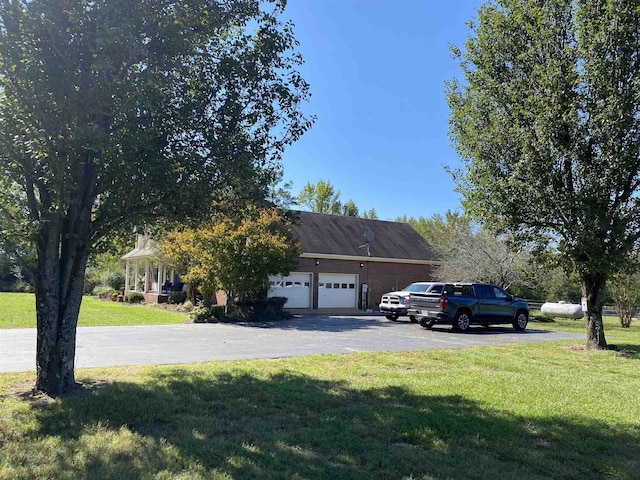 2845 Gilchrist Stantonville Rd, Stantonville, TN 38379 - view of front of home with an attached garage, driveway, and a front yard