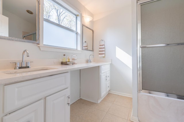 bathroom featuring tile patterned floors, a shower with shower door, and vanity