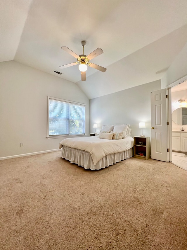 unfurnished bedroom with lofted ceiling, carpet floors, ensuite bathroom, and ceiling fan