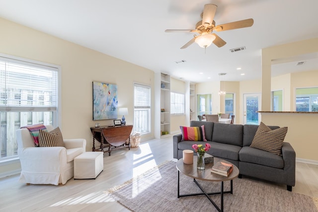 living room with ceiling fan, light hardwood / wood-style flooring, and a healthy amount of sunlight