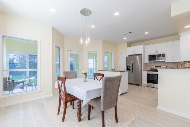 dining room featuring light hardwood / wood-style flooring and sink