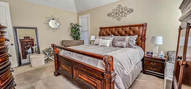 carpeted bedroom with lofted ceiling