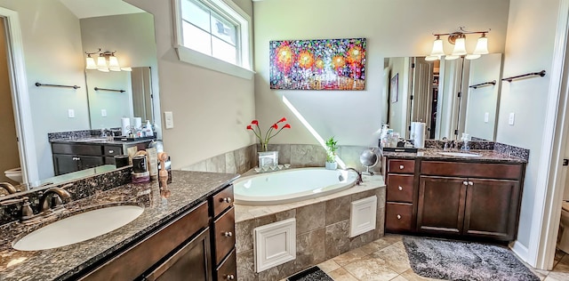 bathroom with vanity, a bathtub, tile patterned flooring, and toilet