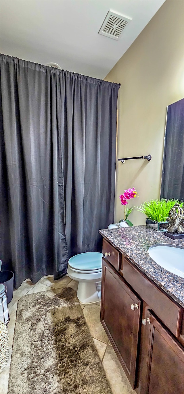 bathroom with tile patterned floors, vanity, and toilet