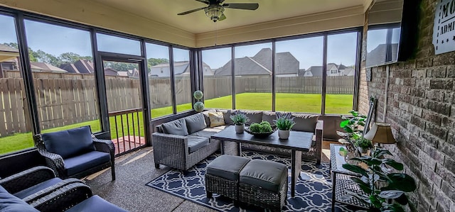 sunroom / solarium featuring a wealth of natural light and ceiling fan