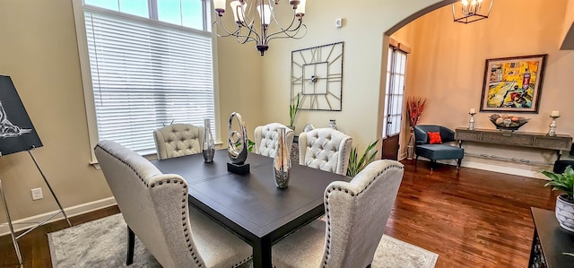 dining room with a notable chandelier and dark hardwood / wood-style floors