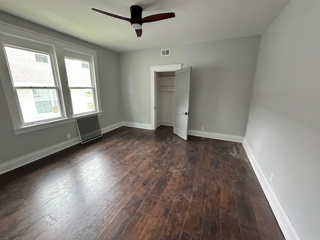 unfurnished bedroom featuring ceiling fan, a closet, and dark hardwood / wood-style floors