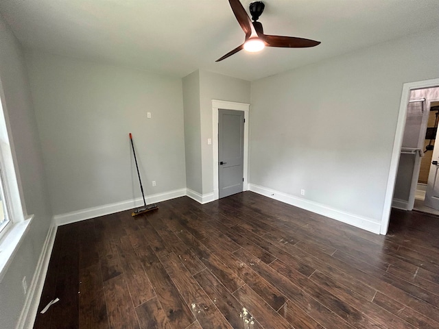 spare room featuring dark wood-type flooring and ceiling fan