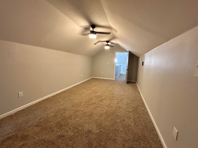 additional living space with lofted ceiling, ceiling fan, and carpet