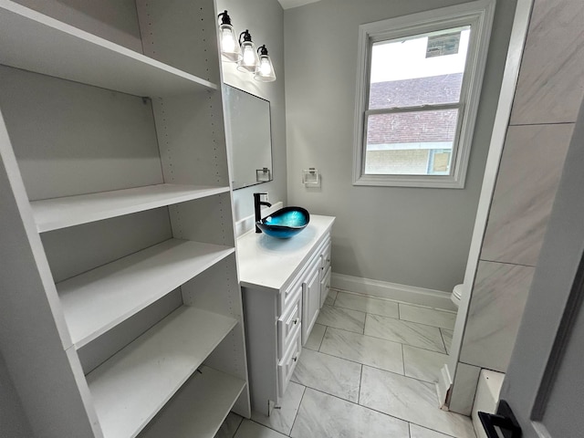 bathroom featuring vanity and toilet