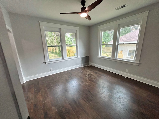 empty room featuring ceiling fan and dark hardwood / wood-style flooring