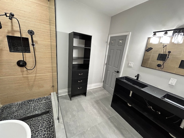 bathroom featuring a shower and vanity