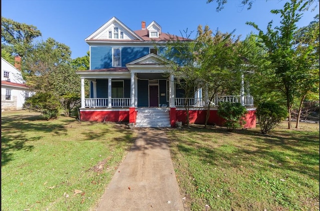 view of front of property with a front yard and covered porch