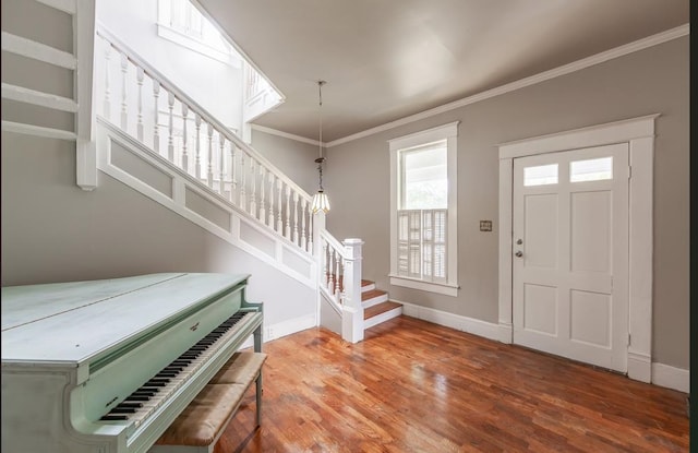 entrance foyer featuring hardwood / wood-style flooring and ornamental molding