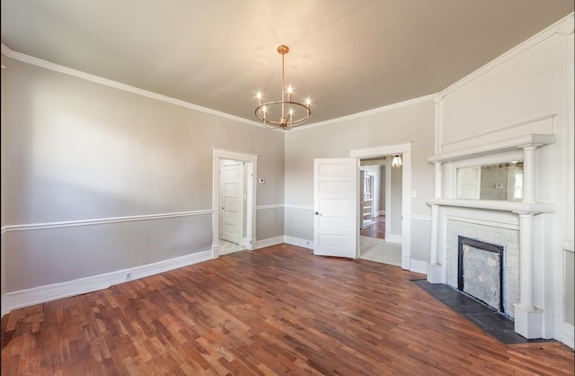 unfurnished living room featuring ornamental molding, a fireplace, an inviting chandelier, and dark hardwood / wood-style floors