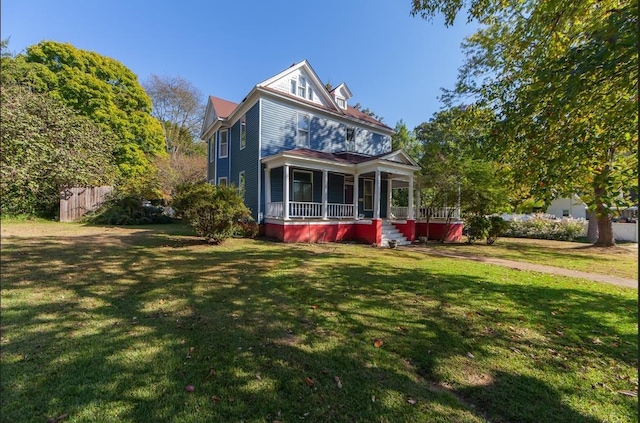 view of front of house with a porch and a front yard