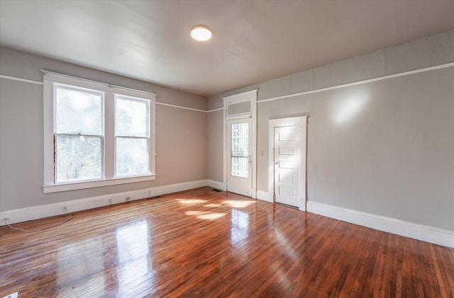 empty room with hardwood / wood-style flooring