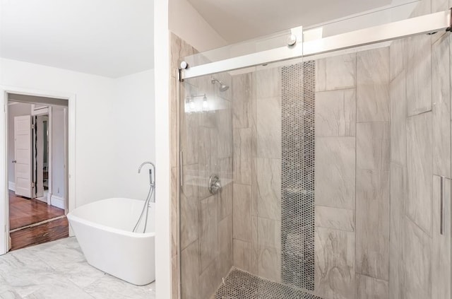 bathroom featuring separate shower and tub