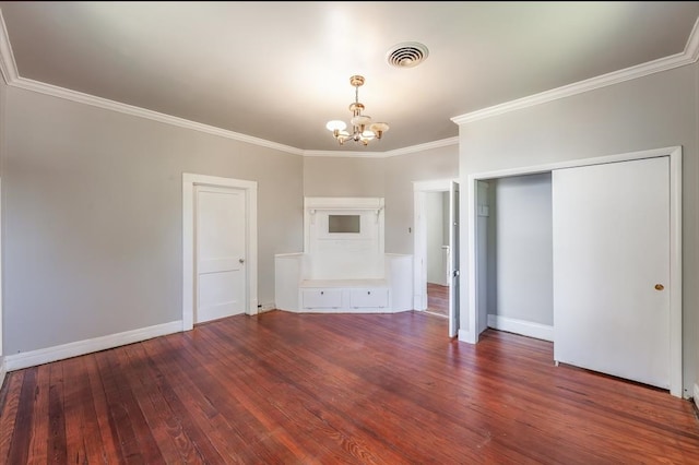 unfurnished living room featuring ornamental molding, hardwood / wood-style flooring, and a notable chandelier