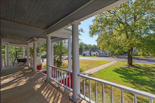 deck with a yard and a porch