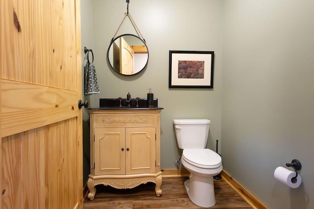 bathroom with vanity, hardwood / wood-style floors, and toilet