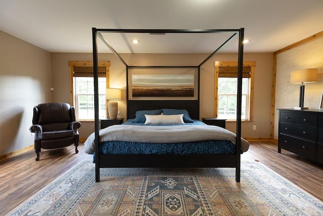 bedroom featuring hardwood / wood-style flooring and multiple windows