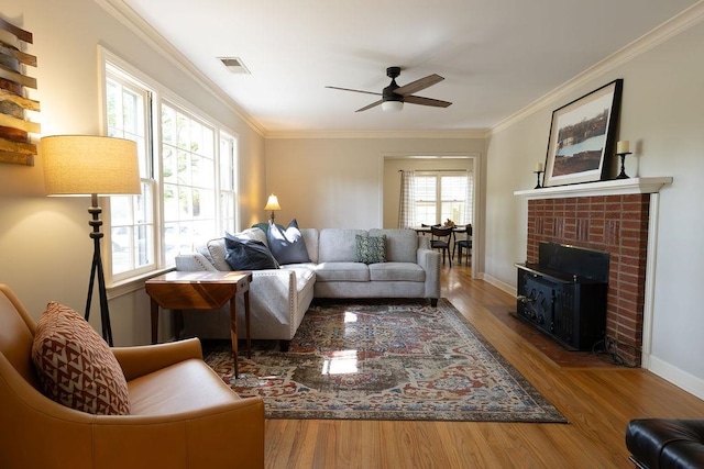 living room with ornamental molding, hardwood / wood-style floors, a wealth of natural light, and ceiling fan