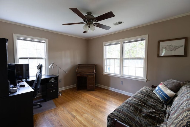 office space with ornamental molding, light wood-type flooring, and ceiling fan