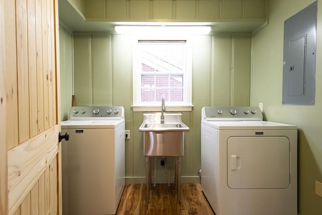 laundry room featuring separate washer and dryer, electric panel, dark hardwood / wood-style floors, and sink